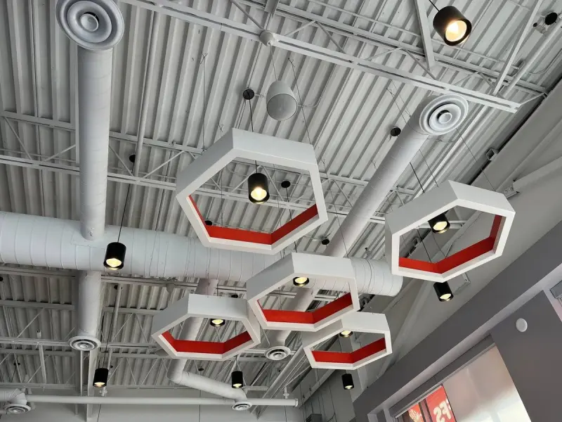 Finished Mr. Puffs café with hexagon feature lights and exposed ductwork